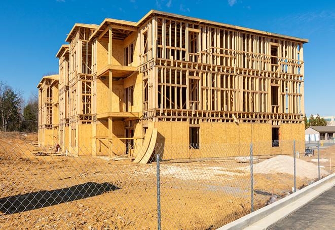 a temporary chain link fence in front of a building under construction, ensuring public safety in Sagamore Hills